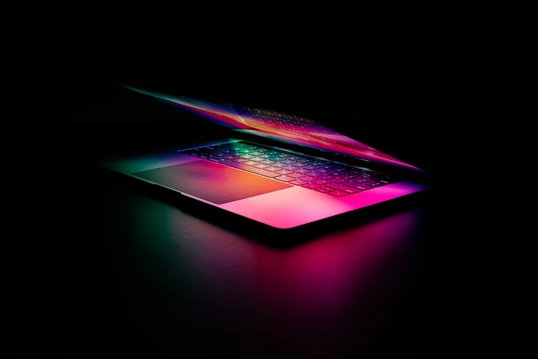 A laptop keyboard lit in vivid colours