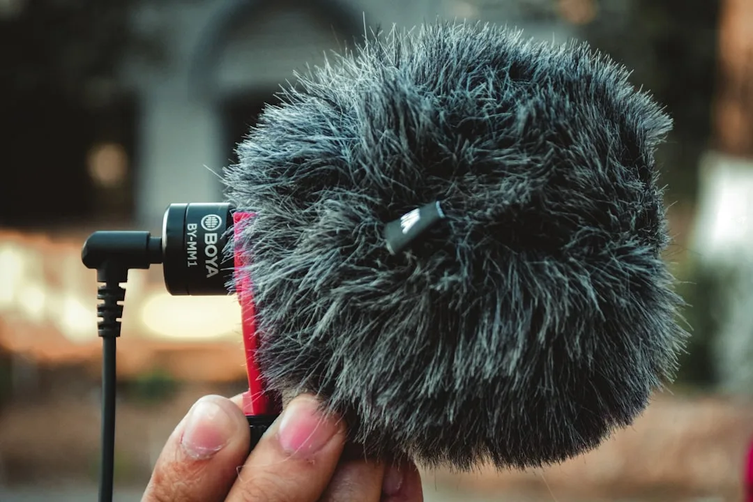A close-up of a hand holding a microphone