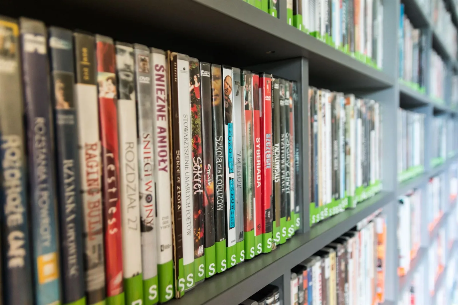 Shelves lined with dozens of film cases in different titles and colours