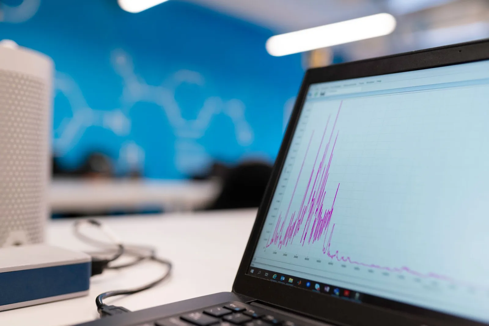 A laptop screen showing a rising graph
